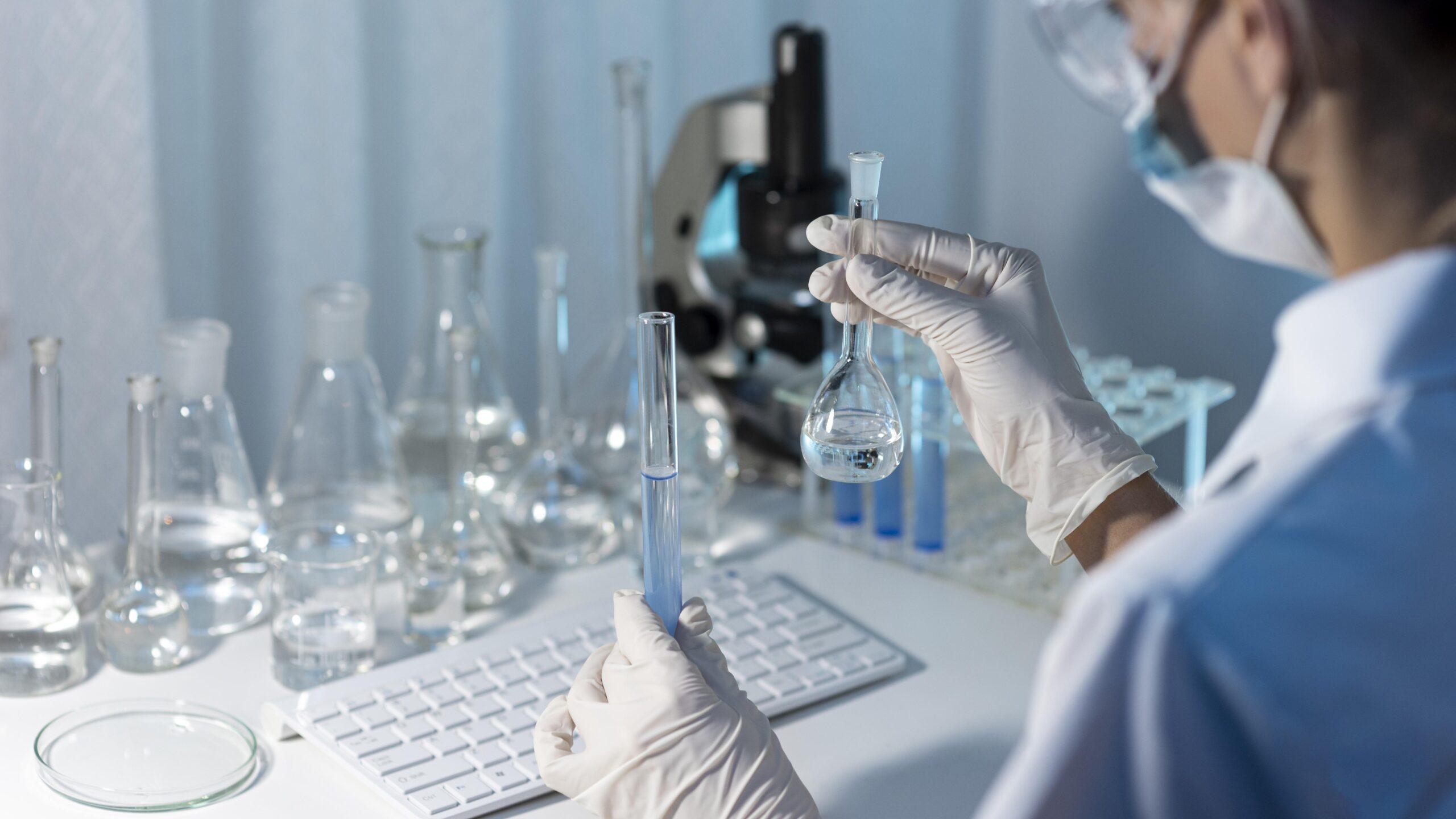 close-up-researcher-holding-glassware